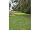 Lush green backyard featuring a patch of grass and mature trees at 5342 Rabbit Ridge Trl, Orlando, FL 32818