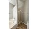 Bathroom featuring a corner tub and glass shower enclosure at 5342 Rabbit Ridge Trl, Orlando, FL 32818