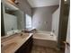 Bright bathroom featuring double sinks, a soaking tub, and a separate shower at 5342 Rabbit Ridge Trl, Orlando, FL 32818