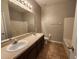 Bathroom featuring dual sinks, a large mirror, and a separate shower and tub at 5342 Rabbit Ridge Trl, Orlando, FL 32818