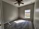 Carpeted bedroom with a ceiling fan and window providing natural light at 5342 Rabbit Ridge Trl, Orlando, FL 32818