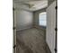 Cozy bedroom with neutral carpet, ceiling fan, window and white door at 5342 Rabbit Ridge Trl, Orlando, FL 32818