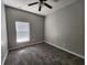 Spacious bedroom featuring plush carpeting, a ceiling fan, and a bright window at 5342 Rabbit Ridge Trl, Orlando, FL 32818