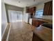 Functional kitchen area with tile flooring, ample counter space, classic cabinets, and sliding door at 5342 Rabbit Ridge Trl, Orlando, FL 32818