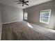 Large main bedroom with carpeting, ceiling fan and natural light from the windows at 5342 Rabbit Ridge Trl, Orlando, FL 32818