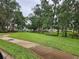 Scenic park view with mature trees and sidewalks winding through the green space at 5342 Rabbit Ridge Trl, Orlando, FL 32818