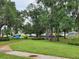 Neighborhood park view featuring mature trees and a sidewalk winding through green space at 5342 Rabbit Ridge Trl, Orlando, FL 32818