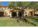 Grassy backyard with a large tree, views of the screened-in patio, and a fence at 5373 Via Appia Way, Sanford, FL 32771