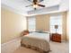 Bright bedroom with tray ceiling, ceiling fan, carpet flooring, and two windows at 5373 Via Appia Way, Sanford, FL 32771
