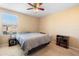 Cozy bedroom with a ceiling fan, large window, and bedside table at 5373 Via Appia Way, Sanford, FL 32771