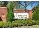 A brick community sign with the name 'Terracina at Lake Forest' surrounded by greenery at 5373 Via Appia Way, Sanford, FL 32771