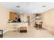 Open-concept kitchen with breakfast bar leading to carpeted stairs with white railing at 5373 Via Appia Way, Sanford, FL 32771