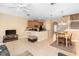 Open concept living room area with a view of the kitchen, stairs and dining table at 5373 Via Appia Way, Sanford, FL 32771