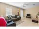 Comfortable living room featuring neutral-toned walls, tile flooring and sliding glass door to patio at 5373 Via Appia Way, Sanford, FL 32771