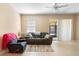 Comfortable living room with neutral-toned walls and tile flooring and sliding glass door to patio at 5373 Via Appia Way, Sanford, FL 32771