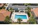 Aerial view of a community pool with lounge chairs and surrounding greenery at 5373 Via Appia Way, Sanford, FL 32771