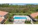 Aerial view of a refreshing community pool, surrounded by landscaping and trees at 5373 Via Appia Way, Sanford, FL 32771
