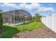 Expansive backyard featuring a screened-in pool, ideal for outdoor living and relaxation at 548 Burford Cir, Davenport, FL 33896