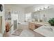 Bright bathroom features a walk-in shower, garden tub, and double sinks at 548 Burford Cir, Davenport, FL 33896