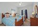 Bedroom with two twin beds, ceiling fan, carpet, and matching furnishings at 548 Burford Cir, Davenport, FL 33896