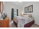 Bedroom with white walls, carpet, ceiling fan, and floral-themed bed coverings at 548 Burford Cir, Davenport, FL 33896