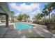 A beautiful community pool area with lounge chairs and mature landscaping at 548 Burford Cir, Davenport, FL 33896