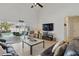 Spacious living room with high ceilings, tile flooring, comfortable leather seating, and sliding glass doors to a pool area at 548 Burford Cir, Davenport, FL 33896