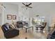 Spacious living room with high ceilings, tile flooring, comfortable leather seating, and sliding glass doors to a pool area at 548 Burford Cir, Davenport, FL 33896
