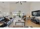 Spacious living room with high ceilings, tile flooring, comfortable leather seating, and sliding glass doors to a pool area at 548 Burford Cir, Davenport, FL 33896