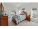 Light-filled main bedroom with a king bed and a view to the pool at 548 Burford Cir, Davenport, FL 33896