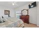 A bright main bedroom features a dresser and sliding glass doors at 548 Burford Cir, Davenport, FL 33896