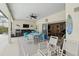 Large screened-in patio featuring seating, table, grill, and view into the home at 548 Burford Cir, Davenport, FL 33896