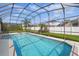 A screened-in pool offers a refreshing escape in a private backyard setting at 548 Burford Cir, Davenport, FL 33896