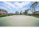 Well-maintained tennis court surrounded by lush landscaping, perfect for recreational enjoyment in a community setting at 548 Burford Cir, Davenport, FL 33896