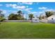 Expansive backyard featuring a well-maintained lawn, storage shed, and white fence, perfect for outdoor activities at 5900 Lyle St, Orlando, FL 32807