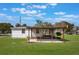 Expansive backyard featuring a cozy patio and screened-in porch, perfect for enjoying the outdoors at 5900 Lyle St, Orlando, FL 32807