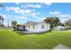 A large, well-manicured lawn surrounds this quaint home with an enclosed back patio at 5900 Lyle St, Orlando, FL 32807