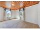 Inviting bedroom with two windows, wood ceiling, and neutral carpeting, creating a bright and airy space at 5900 Lyle St, Orlando, FL 32807
