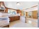 Efficient kitchen layout with wood cabinetry and a breakfast bar leading to the living room at 5900 Lyle St, Orlando, FL 32807