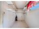 Bright laundry room with abundant shelving and a convenient window for natural light and ventilation at 5900 Lyle St, Orlando, FL 32807