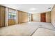 A spacious living room features warm wood paneling and natural light from multiple windows at 5900 Lyle St, Orlando, FL 32807