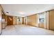 Inviting living room with wood paneling, ample natural light, and comfortable carpet at 5900 Lyle St, Orlando, FL 32807