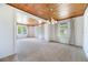 Bright living room featuring hardwood ceiling, carpet flooring, and plenty of natural light at 5900 Lyle St, Orlando, FL 32807