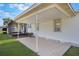 Covered patio adjacent to screened-in porch offers a versatile outdoor living space and serene backyard views at 5900 Lyle St, Orlando, FL 32807