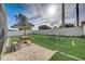 The backyard is turfed with a picnic table and umbrella, with a white vinyl fence surrounding at 611 Saddle Ridge Dr, Davenport, FL 33896