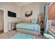 Cozy bedroom with a comfortable bed, TV, and natural light at 611 Saddle Ridge Dr, Davenport, FL 33896
