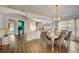 Inviting dining area with stylish furniture, bright windows, and wood flooring at 611 Saddle Ridge Dr, Davenport, FL 33896