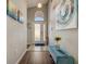 Inviting home foyer with a front door with sidelights, a bench, and decorative artwork at 611 Saddle Ridge Dr, Davenport, FL 33896