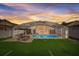 The home features a screened-in pool, turf backyard and an umbrella picnic table perfect for entertaining at 611 Saddle Ridge Dr, Davenport, FL 33896