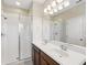 Bathroom showcasing double sinks, a large mirror, and a glass-enclosed shower at 7776 Rigby St, Windermere, FL 34786